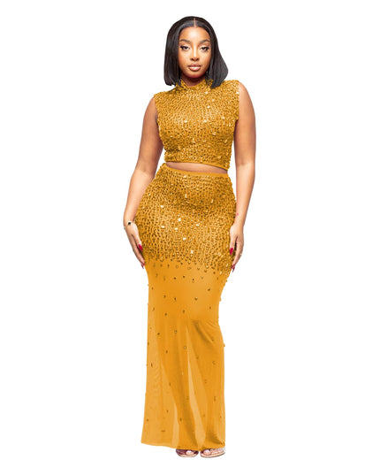 Woman wearing a sparkling gold two-piece outfit on a white background